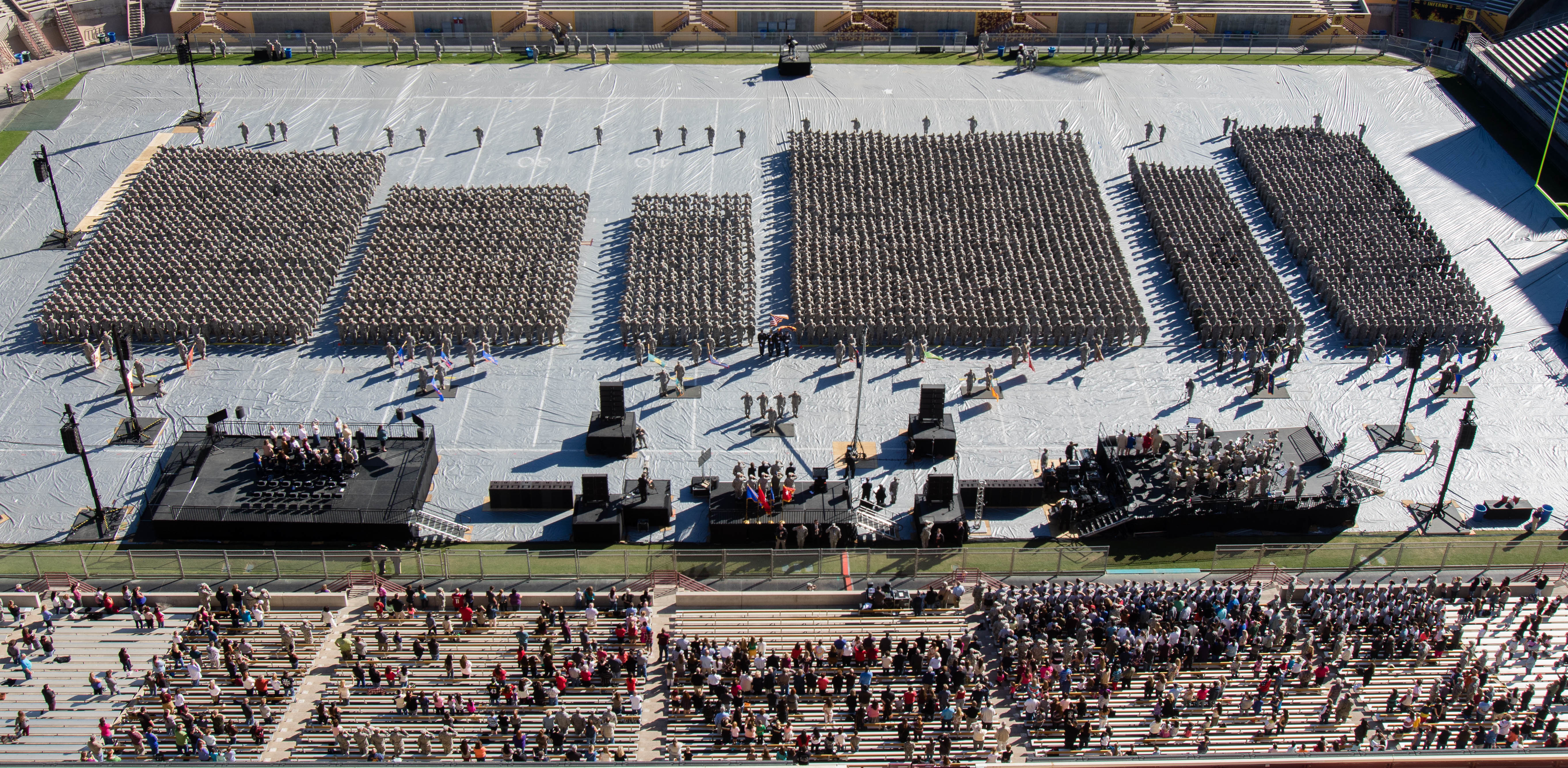 Army National Guard. bird's-eye view of soldiers' information on a football field. audience in the stage viewing the event
