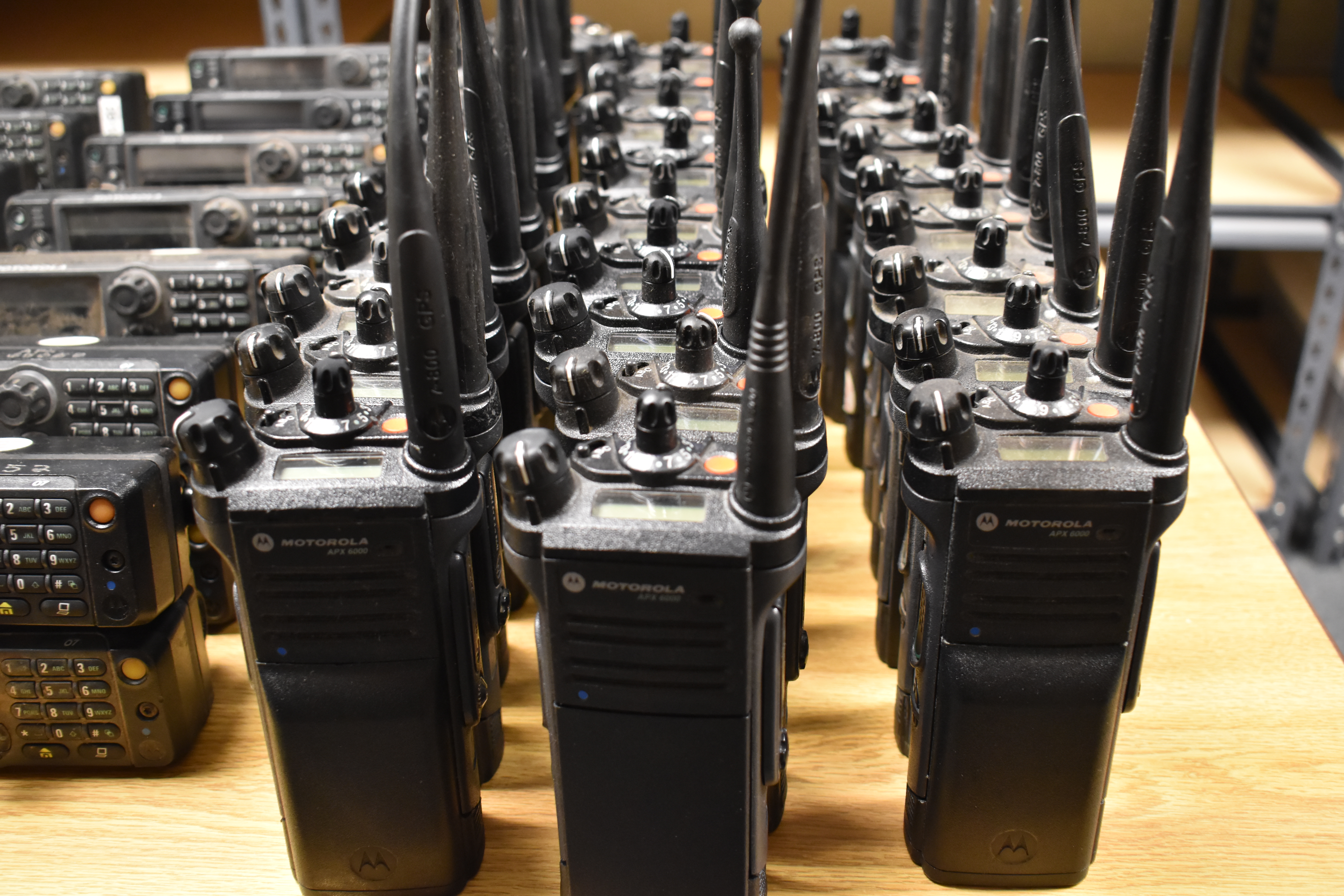 Photo of radios lined up on the table.