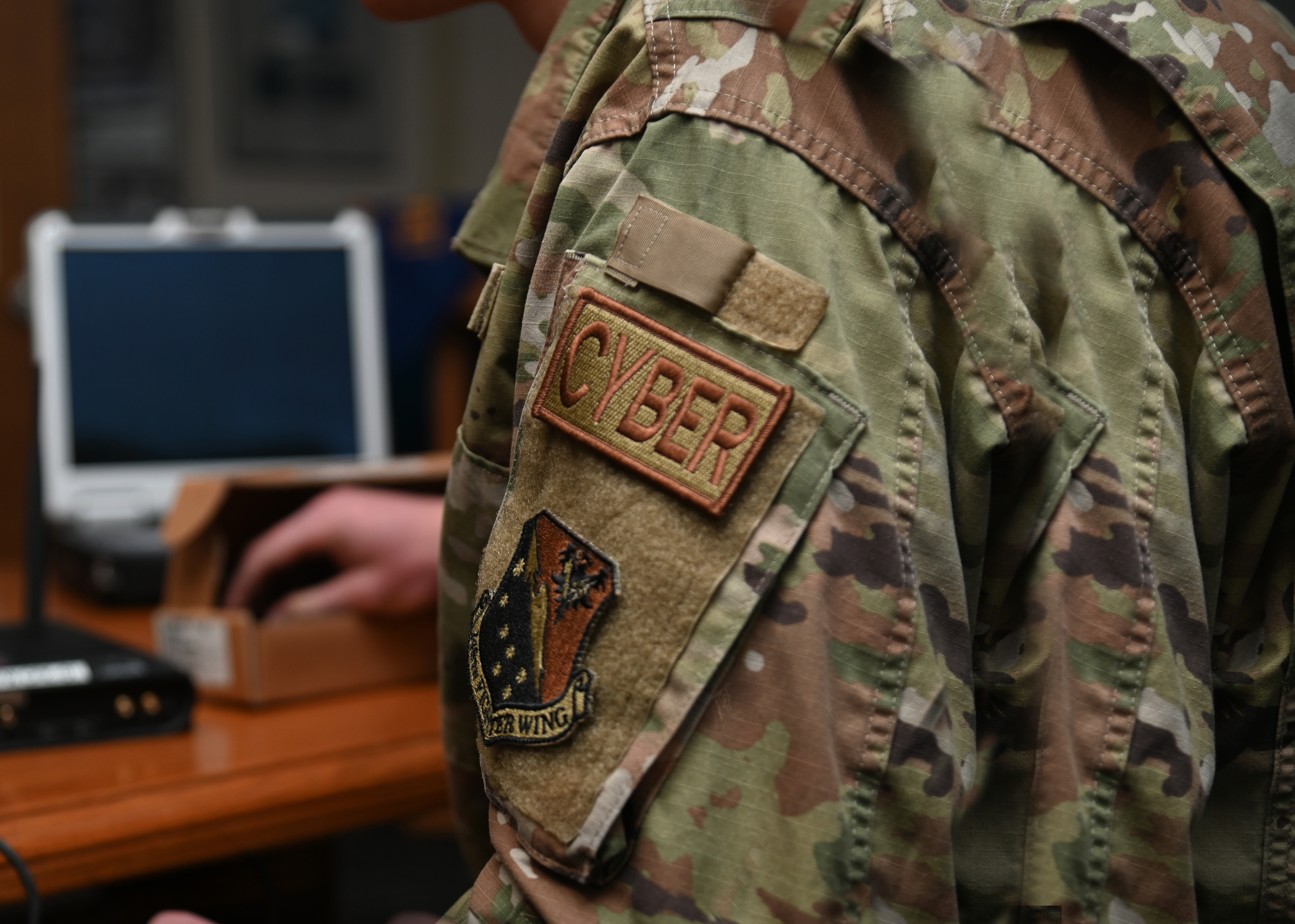 Airman inspects electrical components for radio communication.