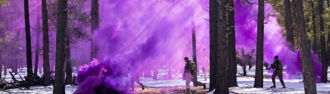 Soldiers employ a smoke grenade to conceal their movement as they prepare to capture a high value target during an urban terrain event in Camp Navajo.