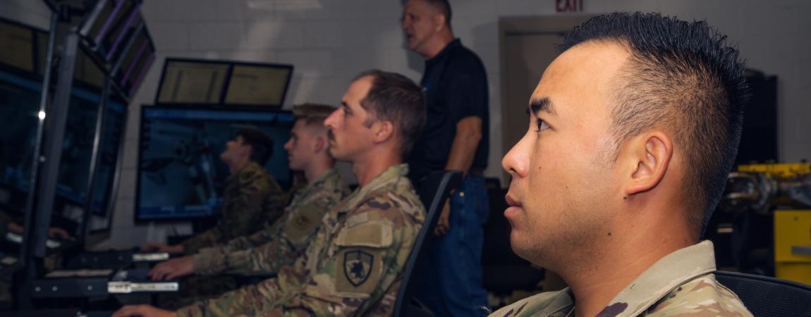 US military personnel on a desktop computer